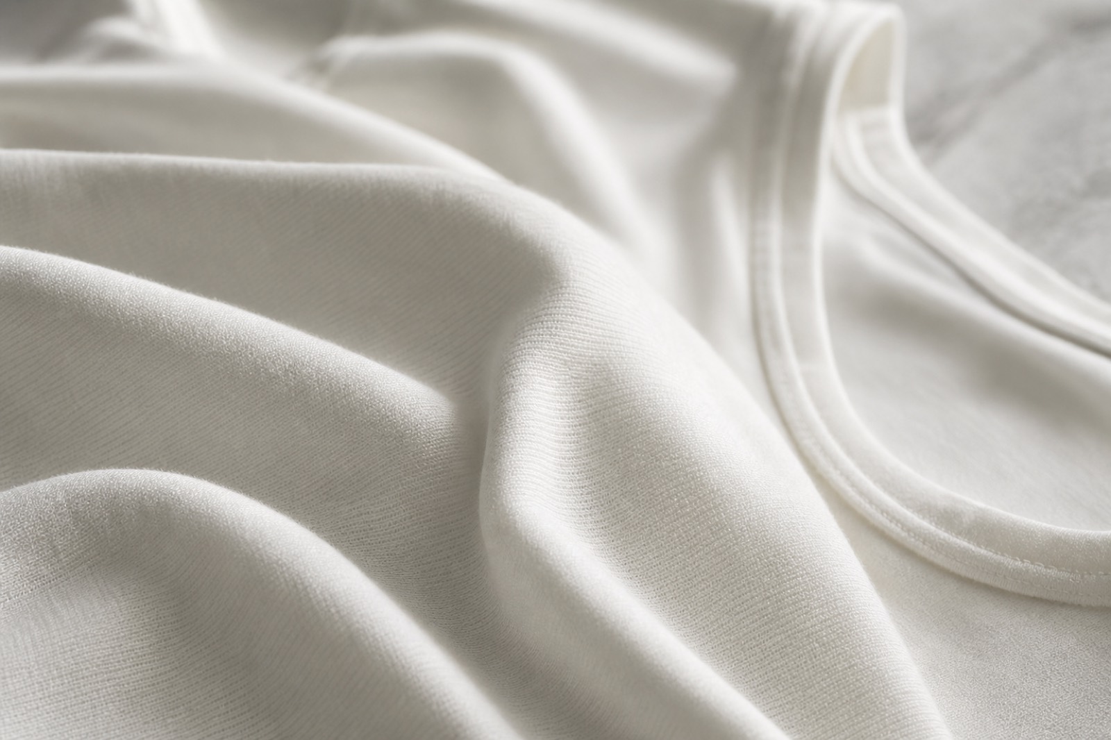 Close-up of fine white cotton knit fabric